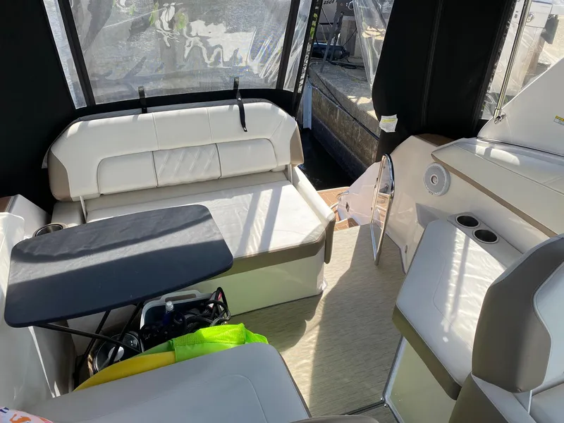 Slide: The Image of 2019 Regal 26 Express boat interior with seating and table, featuring modern design and comfort. - 7