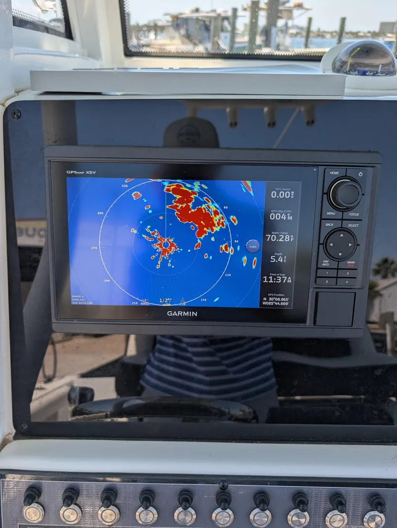 Slide: The Image of Garmin navigation display on 2022 Tidewater 256 CC Adventure boat dashboard. - 13