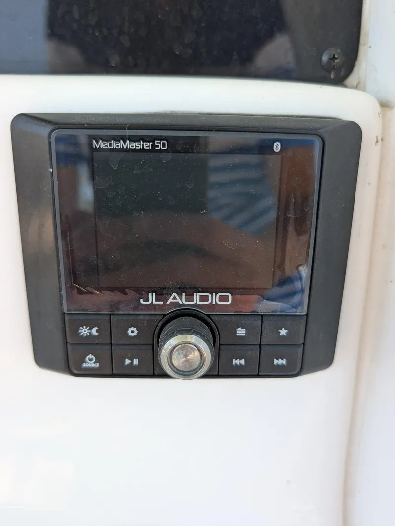 Slide: The Image of JL Audio MediaMaster 50 on 2022 Tidewater 256 CC Adventure boat dashboard. - 14
