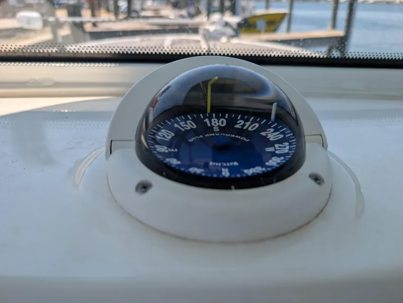 Slide: The Image of Compass on 2022 Tidewater 256 CC Adventure boat, docked at marina. - 15