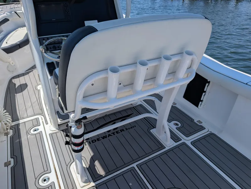 Slide: The Image of 2022 Tidewater 256 CC Adventure boat interior with rod holders and seating. - 24