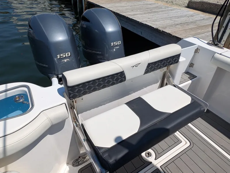 Slide: The Image of 2022 Tidewater 256 CC Adventure boat with dual 150 horsepower engines and comfortable seating. - 26
