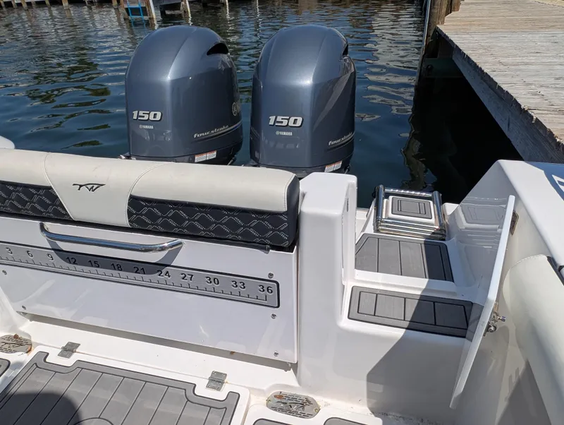 Slide: The Image of 2022 Tidewater 256 CC Adventure boat with twin Yamaha 150 engines at dock. - 27