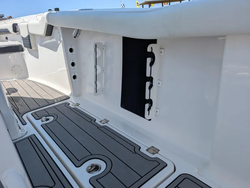 Slide: The Image of 2022 Tidewater 256 CC Adventure boat interior with sleek deck and storage features. - 29