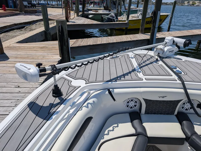 Slide: The Image of 2022 Tidewater 256 CC Adventure boat with trolling motor at dock. - 35