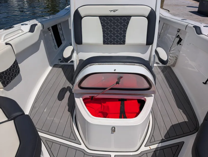 Slide: The Image of 2022 Tidewater 256 CC Adventure boat interior with seating and storage compartment. - 36