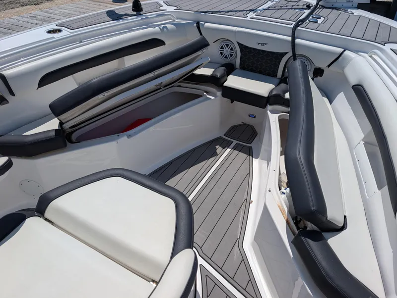Slide: The Image of 2022 Tidewater 256 CC Adventure boat interior with cushioned seating and storage compartments. - 37