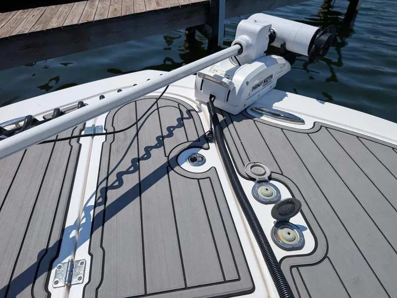 Slide: The Image of 2022 Tidewater 256 CC Adventure boat deck with mounted equipment and sleek design. - 38