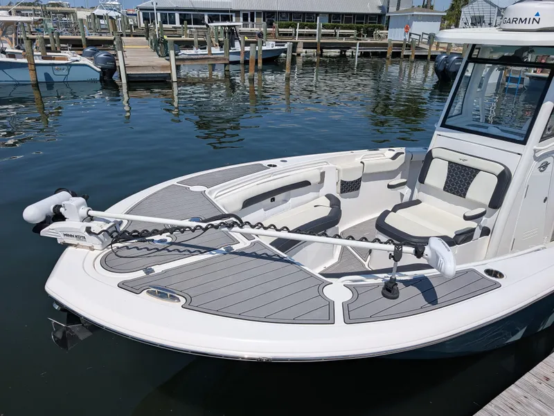 Slide: The Image of 2022 Tidewater 256 CC Adventure boat docked, featuring spacious seating and advanced navigation equipment. - 4