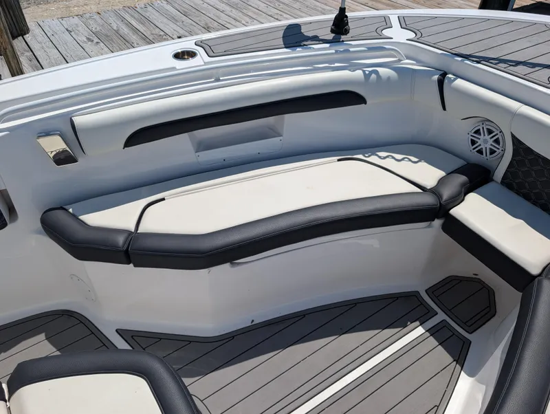 Slide: The Image of 2022 Tidewater 256 CC Adventure boat interior with cushioned seating and modern design. - 40