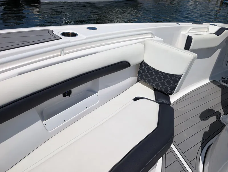 Slide: The Image of 2022 Tidewater 256 CC Adventure boat interior with cushioned seating and sleek design. - 42