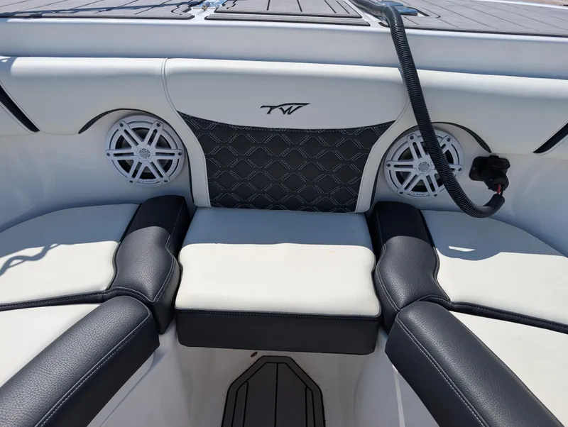 Slide: The Image of 2022 Tidewater 256 CC Adventure boat interior with cushioned seating and built-in speakers. - 43