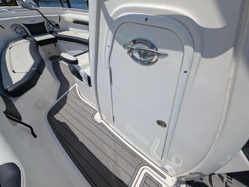 Slide: The Image of 2022 Tidewater 256 CC Adventure boat interior with sleek seating and modern design. - 45