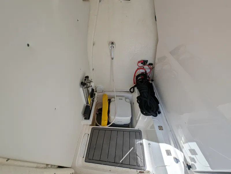 Slide: The Image of 2022 Tidewater 256 CC Adventure boat interior with storage and equipment. - 47