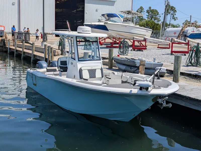 Slide: The Image of 2022 Tidewater 256 CC Adventure boat docked at marina, ready for adventure. - 48