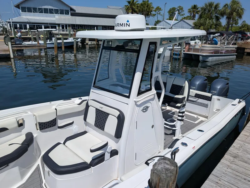 Slide: The Image of 2022 Tidewater 256 CC Adventure boat docked at marina with Garmin equipment. - 5