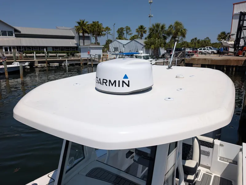 Slide: The Image of 2022 Tidewater 256 CC Adventure boat with Garmin radar, docked at marina. - 9