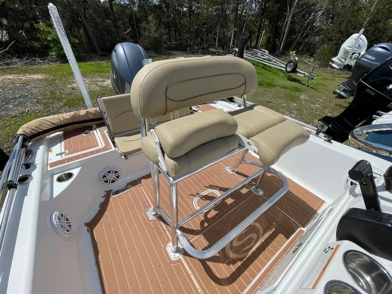 Slide: The Image of 2017 Sportsman Masters 207 Bay Boat interior with beige seating and wood-patterned flooring. - 10