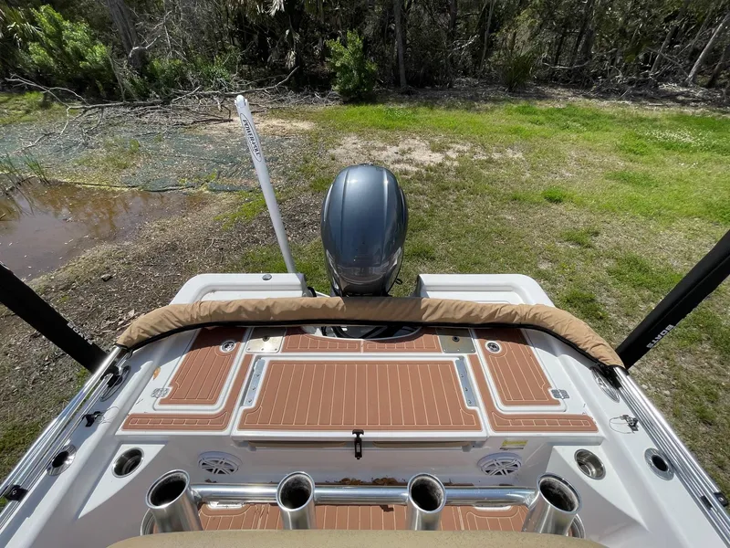 Slide: The Image of 2017 Sportsman Masters 207 Bay Boat with motor, docked on grassy shore. - 11