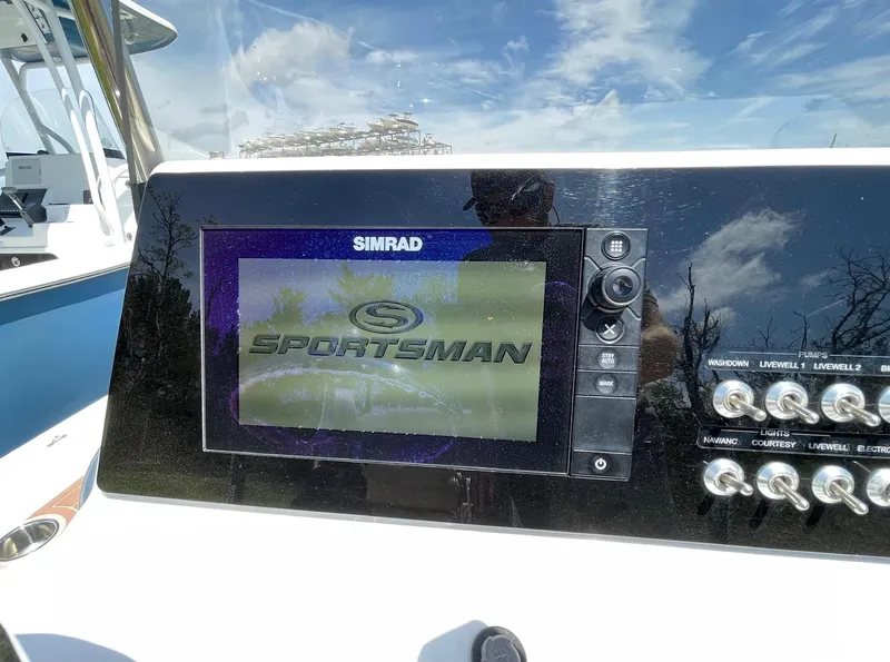 Slide: The Image of Simrad display on 2017 Sportsman Masters 207 Bay Boat dashboard under clear sky. - 13