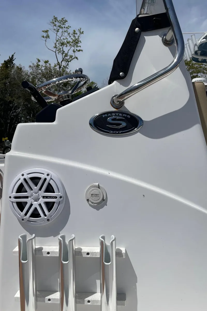 Slide: The Image of 2017 Sportsman Masters 207 Bay Boat console with speaker and rod holders. - 26