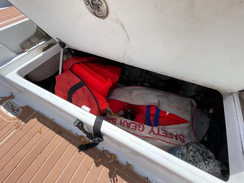 Slide: The Image of Storage compartment on a 2017 Sportsman Masters 207 Bay Boat with safety gear. - 27