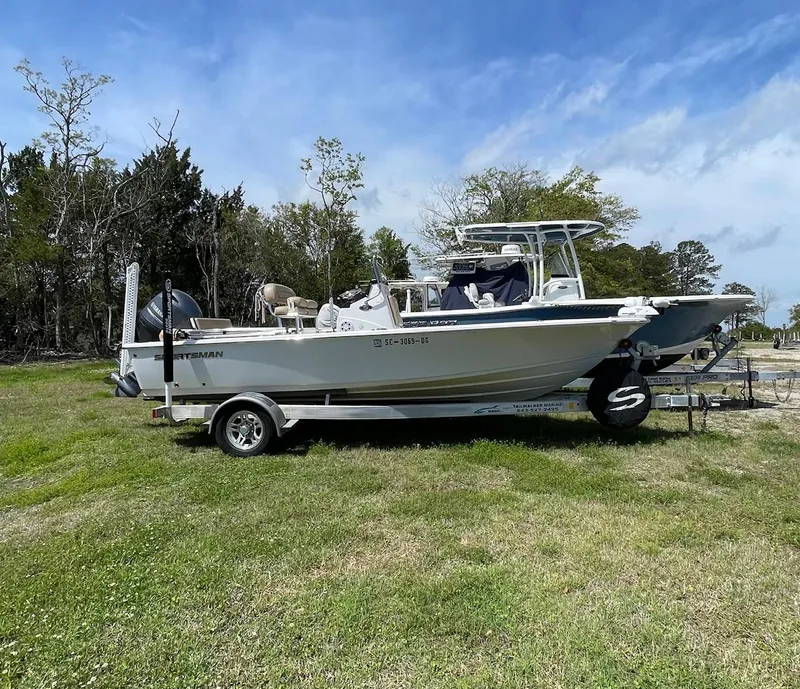 Slide: The Image of 2017 Sportsman Masters 207 Bay Boat on trailer, parked on grassy area. - 3