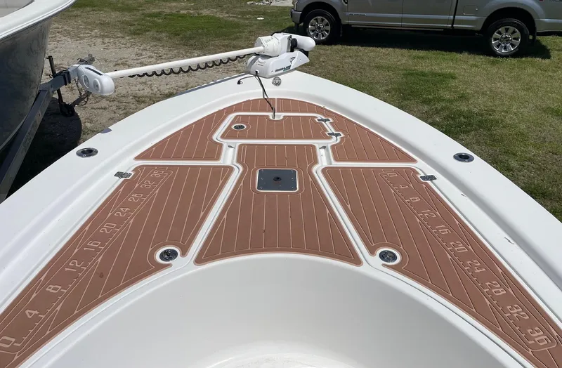 Slide: The Image of 2017 Sportsman Masters 207 Bay Boat deck with brown non-slip surface and trolling motor. - 6