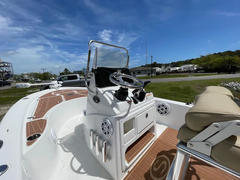 Slide: The Image of 2017 Sportsman Masters 207 Bay Boat with console and seating, under clear blue sky. - 7
