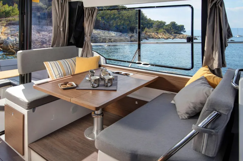 Slide: The Image of Interior of 2020 Jeanneau NC 1095 Fly yacht with cozy seating and scenic ocean view. - 10