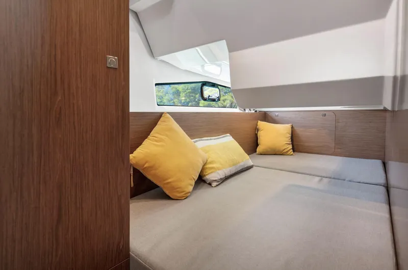 Slide: The Image of Interior cabin of 2020 Jeanneau NC 1095 Fly with cozy seating and yellow cushions. - 14