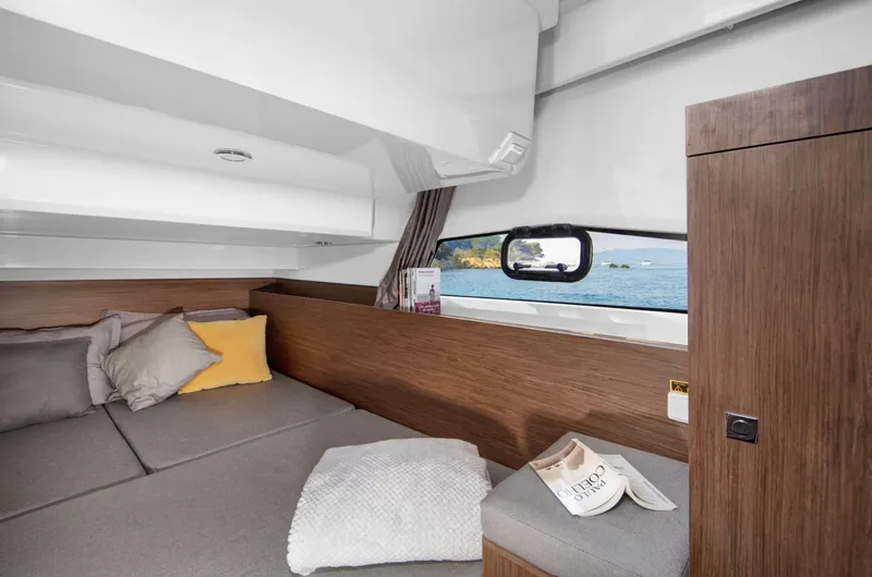 Slide: The Image of 2020 Jeanneau NC 1095 Fly cabin interior with cozy bedding and scenic window view. - 15