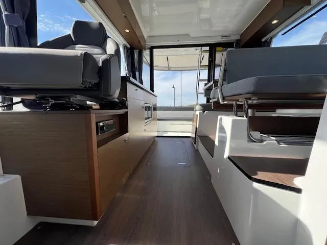 Slide: The Image of Interior of 2020 Jeanneau NC 1095 Fly boat with modern seating and wood finishes. - 23