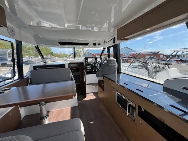 Slide: The Image of Interior of 2020 Jeanneau NC 1095 Fly boat, featuring helm, seating, and modern amenities. - 29