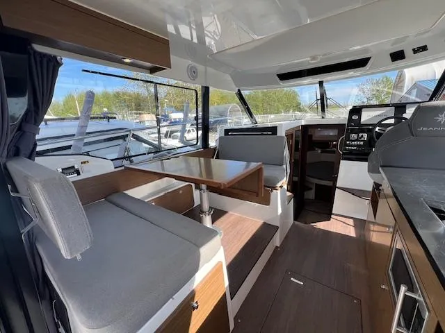 Slide: The Image of Interior of 2020 Jeanneau NC 1095 Fly boat with modern seating and navigation area. - 30