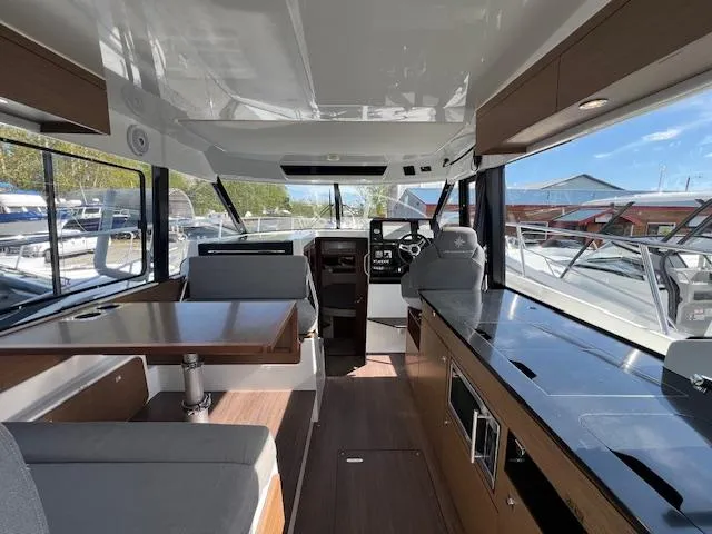Slide: The Image of Interior of 2020 Jeanneau NC 1095 Fly, featuring modern seating and navigation area. - 31