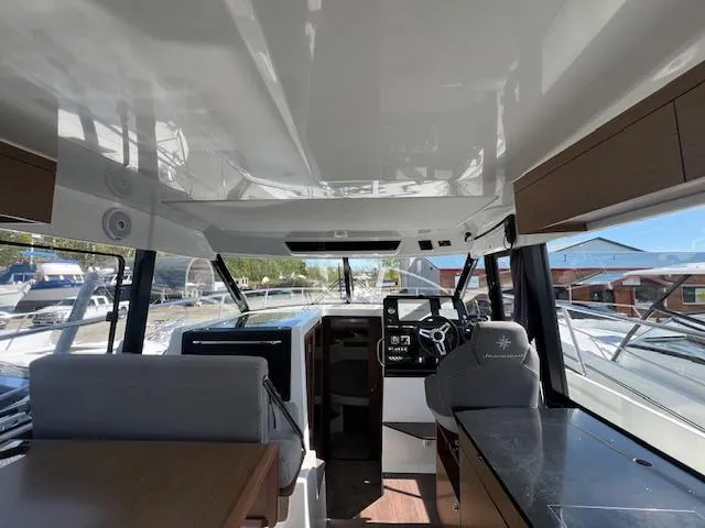 Slide: The Image of Interior view of 2020 Jeanneau NC 1095 Fly boat cockpit with modern controls and seating. - 32