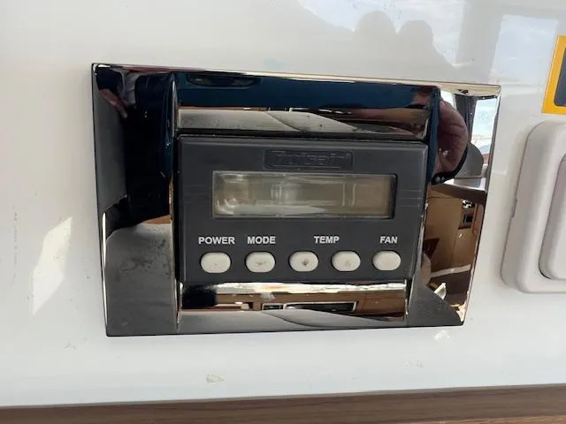 Slide: The Image of Control panel on a 2020 Jeanneau NC 1095 Fly boat, featuring power, mode, temp, and fan buttons. - 34