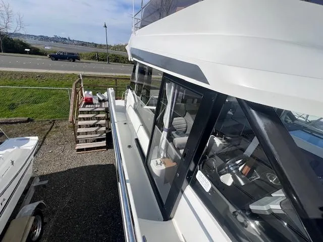 Slide: The Image of 2020 Jeanneau NC 1095 Fly yacht docked, showcasing sleek design and spacious deck. - 36