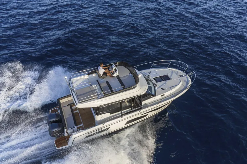 Slide: The Image of 2020 Jeanneau NC 1095 Fly cruising on open water, aerial view. - 4