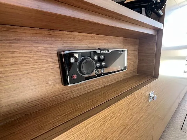 Slide: The Image of Control panel on 2020 Jeanneau NC 1095 Fly boat, set in wooden interior. - 42