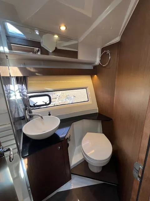 Slide: The Image of 2020 Jeanneau NC 1095 Fly bathroom with modern fixtures and natural lighting. - 46