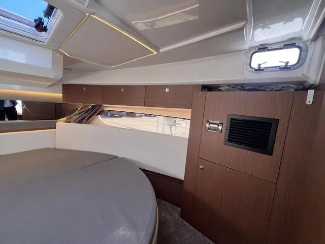 Slide: The Image of 2020 Jeanneau NC 1095 Fly cabin interior with modern wood finish and cozy seating. - 48