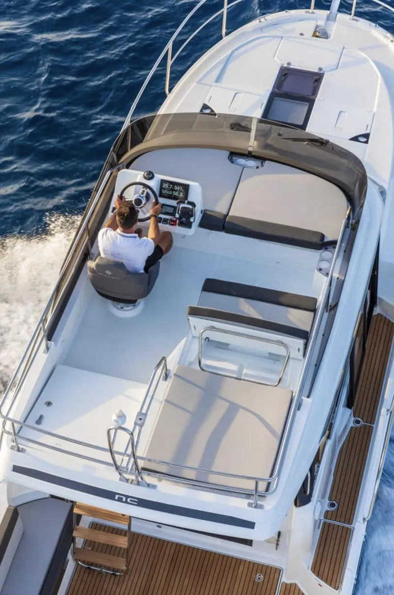 Slide: The Image of 2020 Jeanneau NC 1095 Fly cruising on open water, aerial view of flybridge. - 5