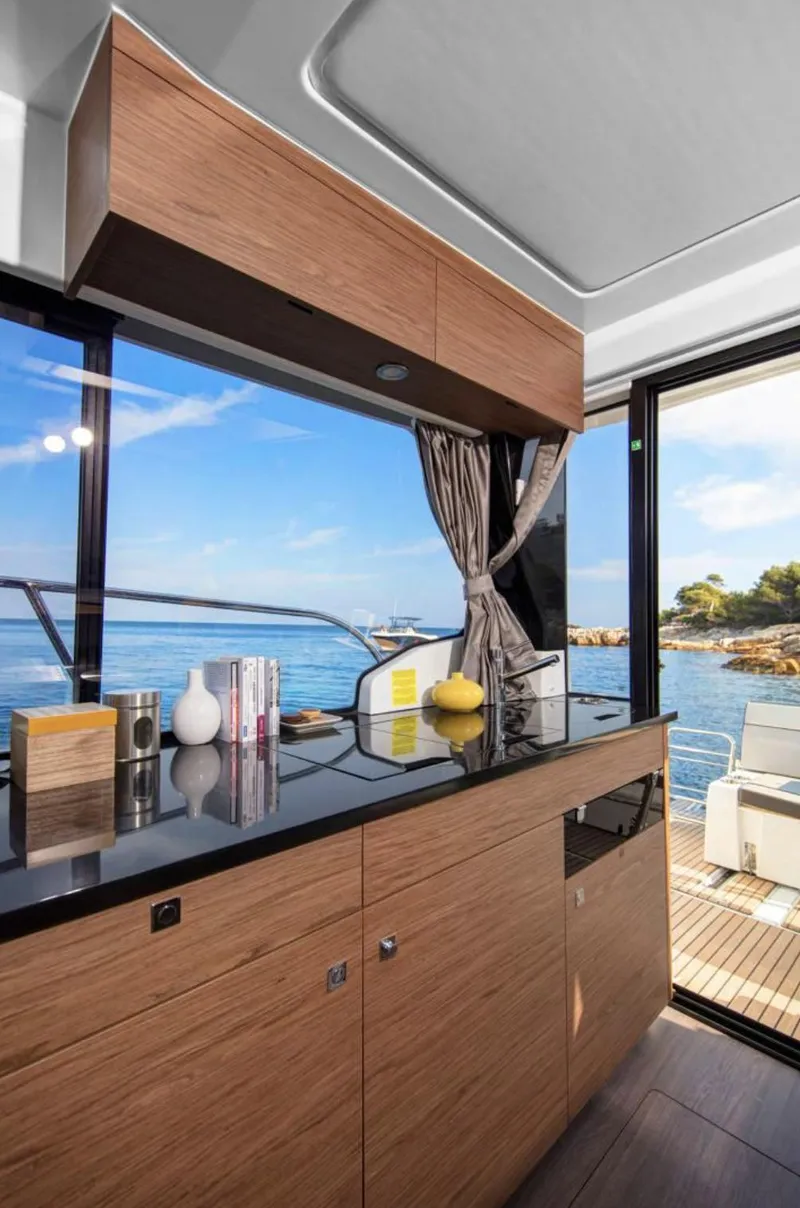 Slide: The Image of Modern kitchen interior on 2020 Jeanneau NC 1095 Fly yacht with ocean view. - 6