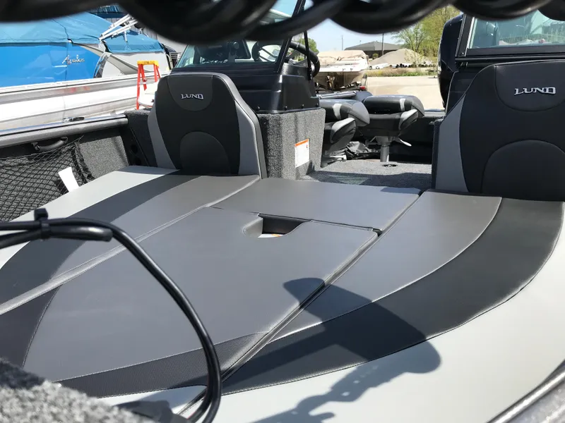 Slide: The Image of 2025 Lund 1875 Impact XS Sport boat interior with sleek seating and modern design. - 12