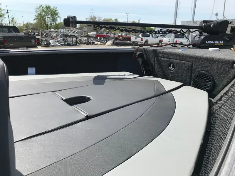 Slide: The Image of 2025 Lund 1875 Impact XS Sport boat interior with storage and fishing equipment. - 16