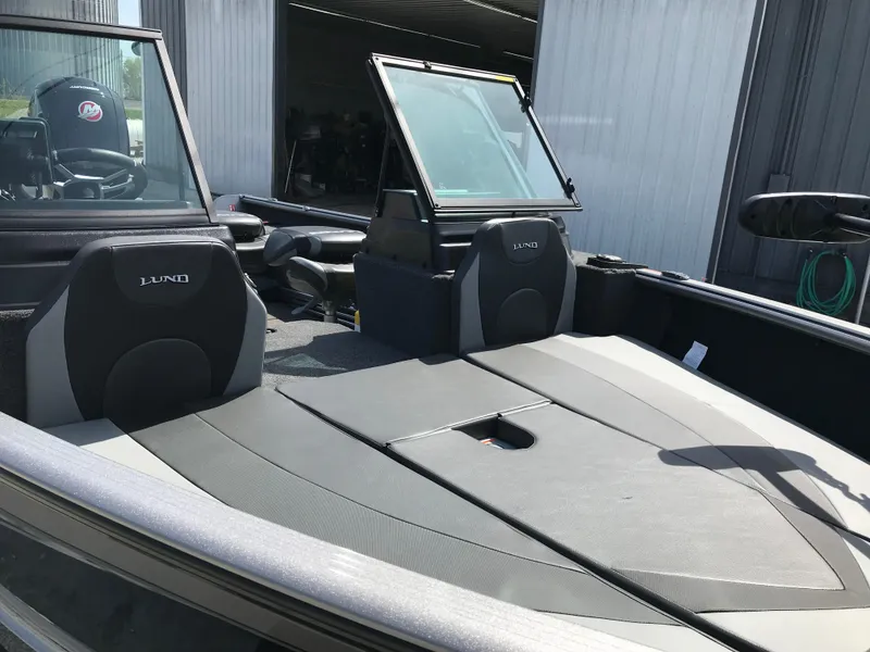 Slide: The Image of 2025 Lund 1875 Impact XS Sport boat interior with open windshield and seating. - 17