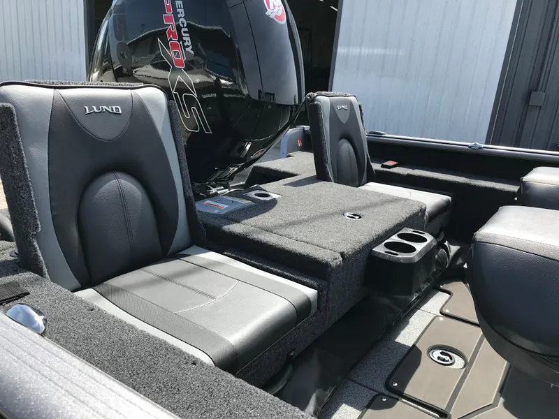 Slide: The Image of 2025 Lund 1875 Impact XS Sport boat interior with seating and motor. - 20