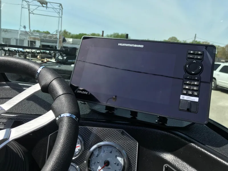 Slide: The Image of 2025 Lund 1875 Impact XS Sport dashboard with Humminbird fish finder and steering wheel. - 22